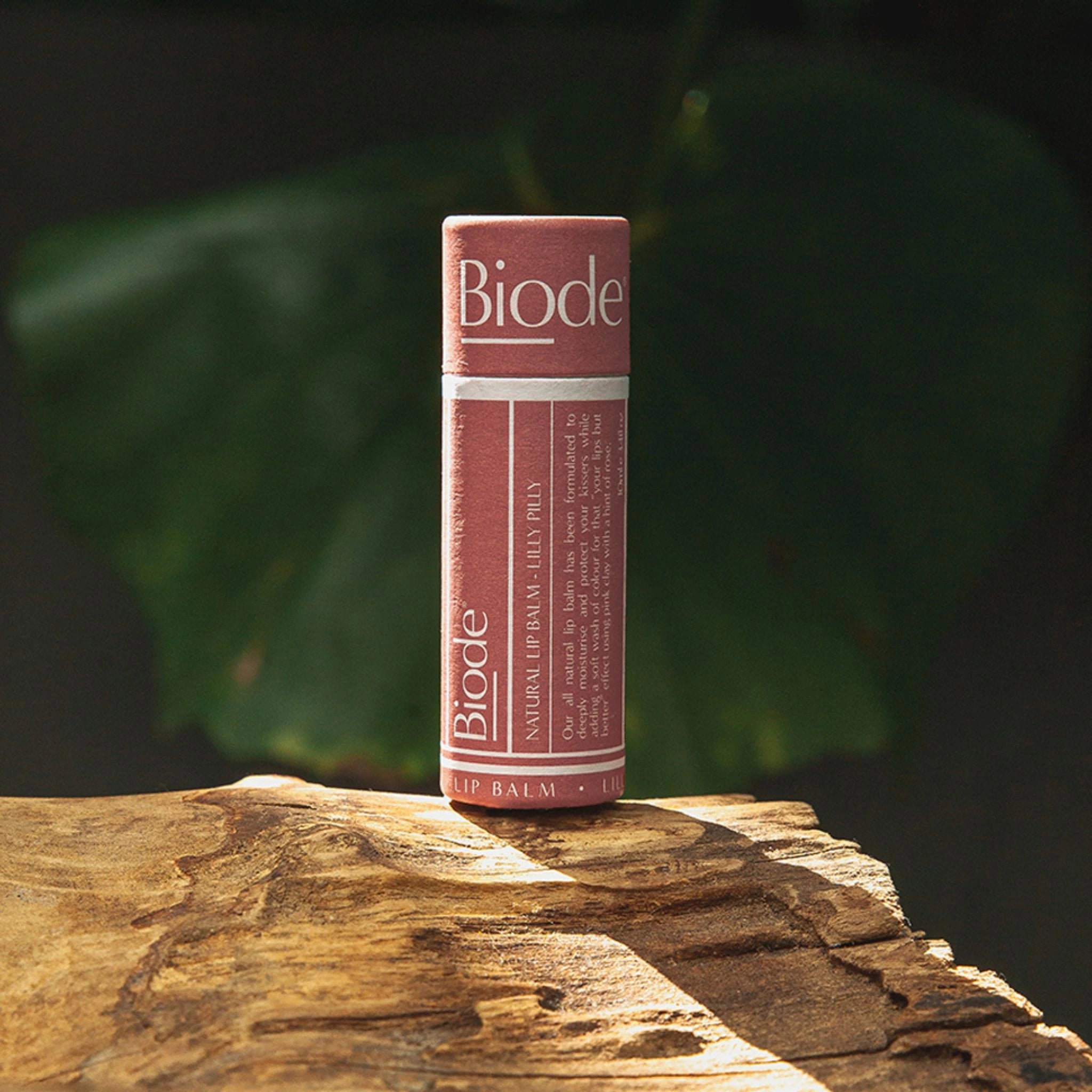 Biode Lilly Pilly lip balm with natural pink tint, shown on wood for eco-conscious skincare