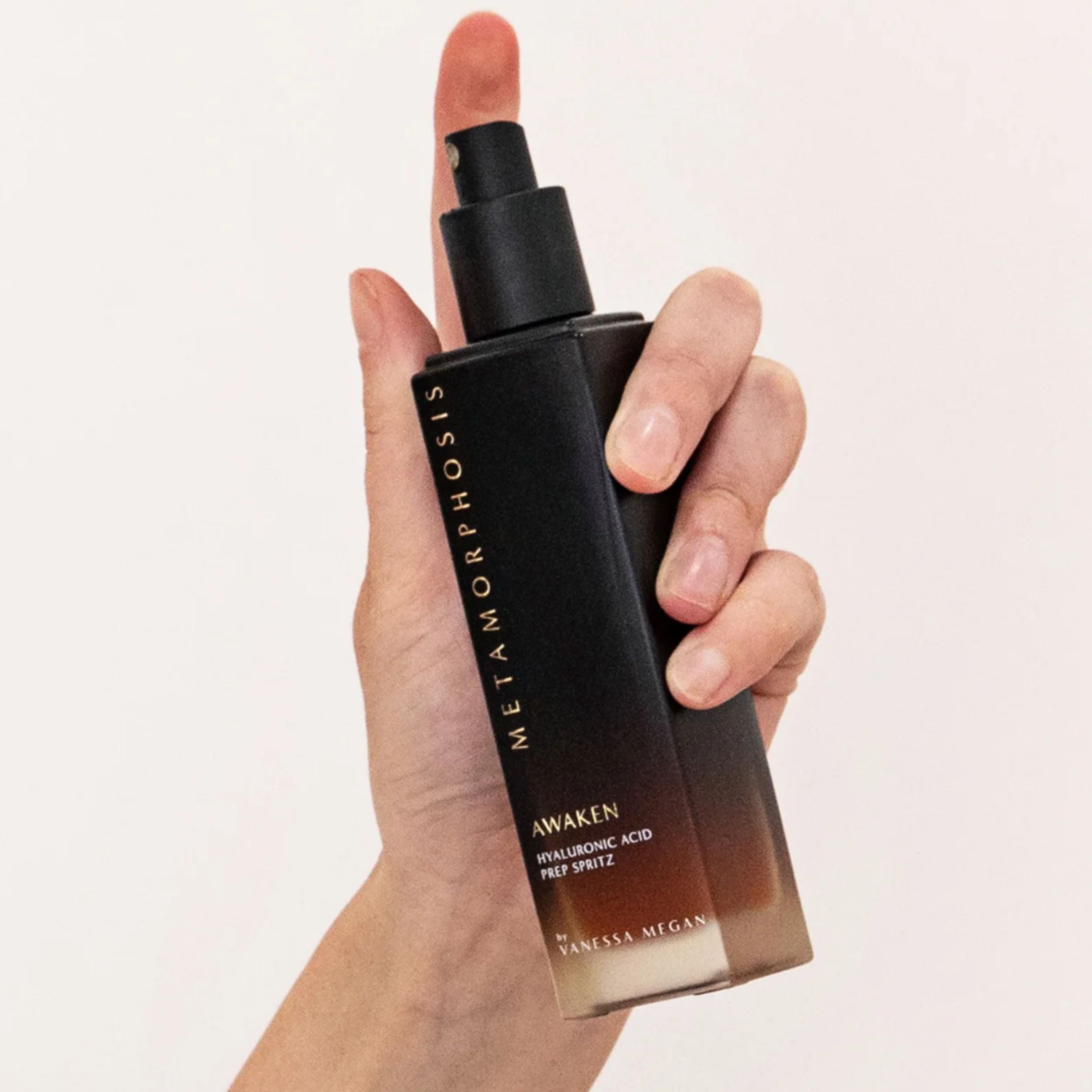 Metamorphosis Awaken Prep Spritz by Vanessa Megan Skincare – hydrating Hyaluronic Acid facial mist held upright in hand, shown mid-spritz at Intentionally Natural NZ.