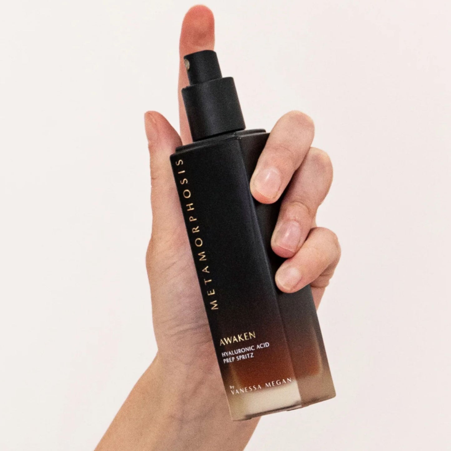 Metamorphosis Awaken Prep Spritz by Vanessa Megan Skincare – hydrating Hyaluronic Acid facial mist held upright in hand, shown mid-spritz at Intentionally Natural NZ.