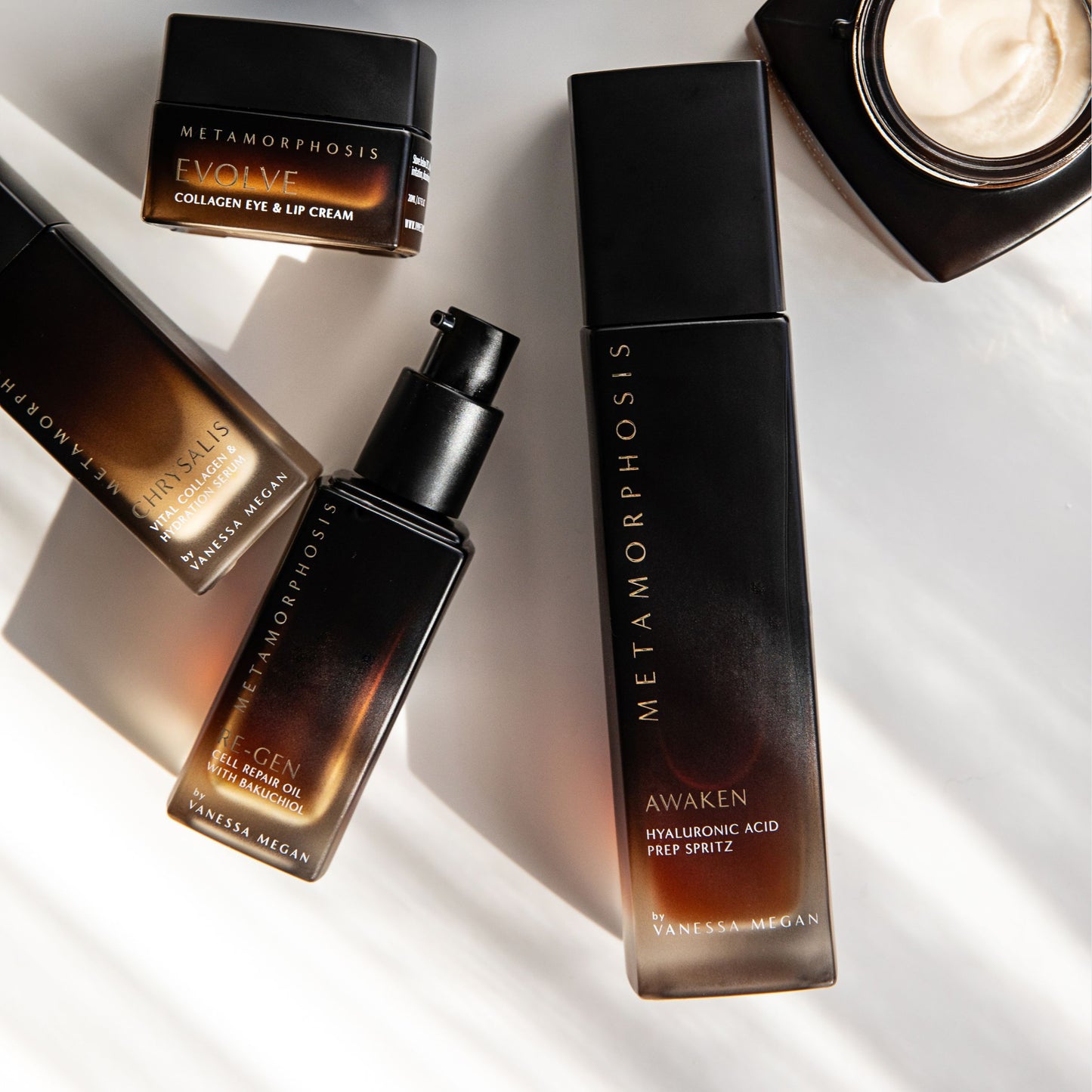 Metamorphosis skincare range by Vanessa Megan – including Awaken Prep Spritz, Re-Gen Cell Repair Oil, Chrysalis Collagen Crème, and Evolve Collagen Eye & Lip Cream – styled in natural light at Intentionally Natural NZ.