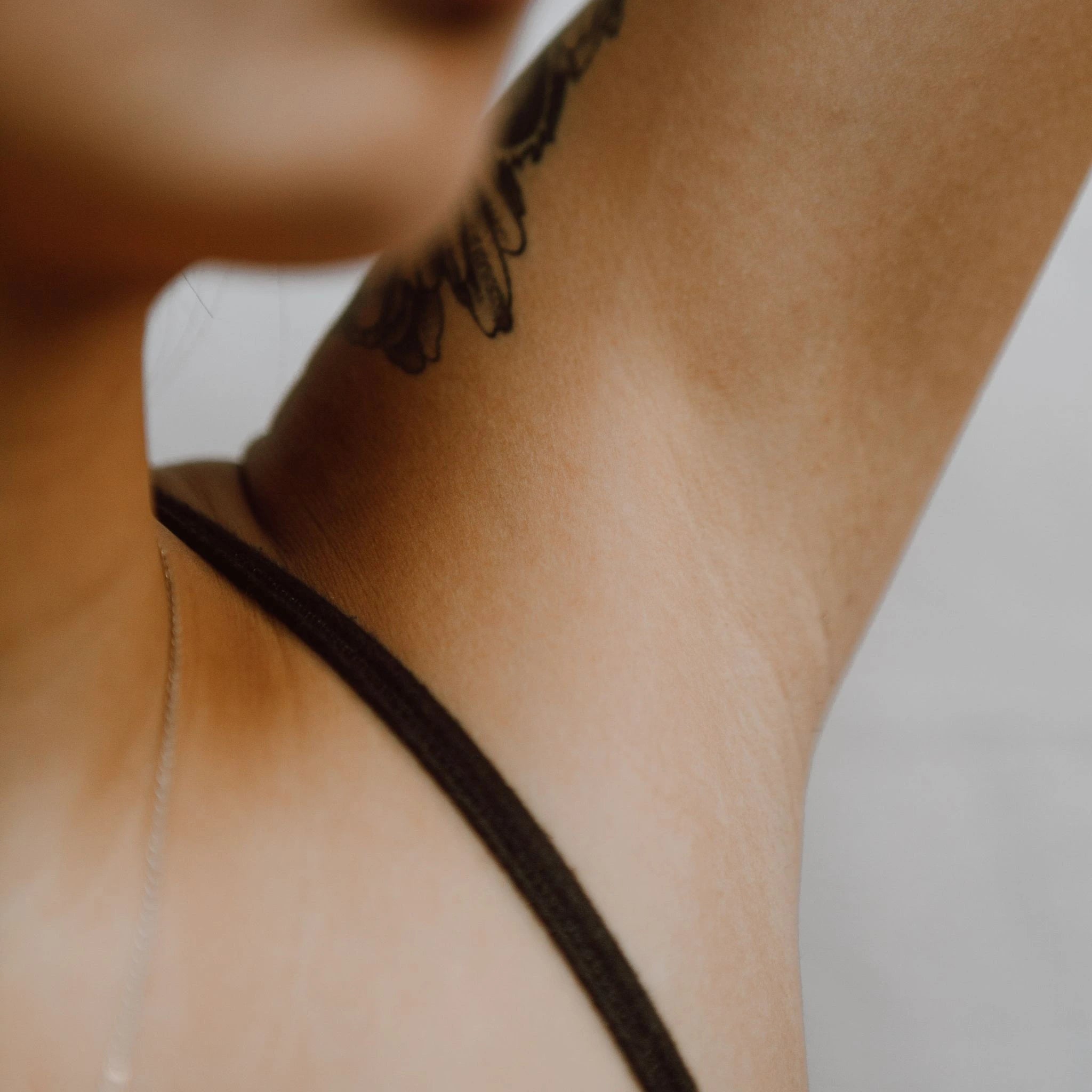 Close-up of a woman’s underarm with natural skin texture, highlighting clean skin and body confidence