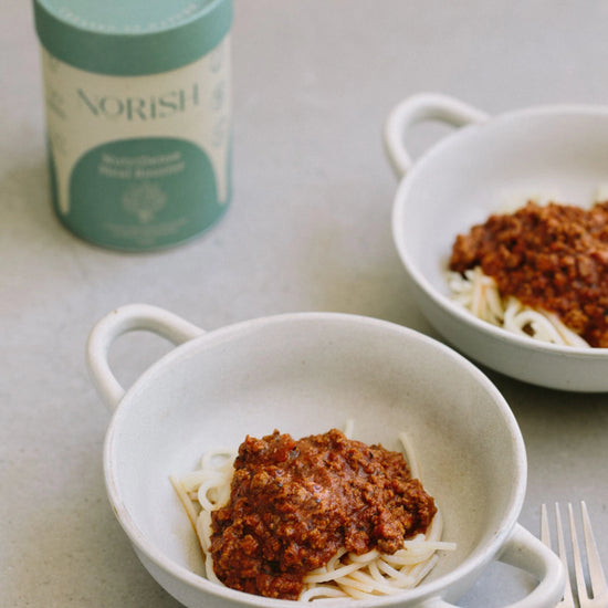 Two bowls of spaghetti with rich, nourishing sauce boosted with Norish NutriDense Meal Booster,