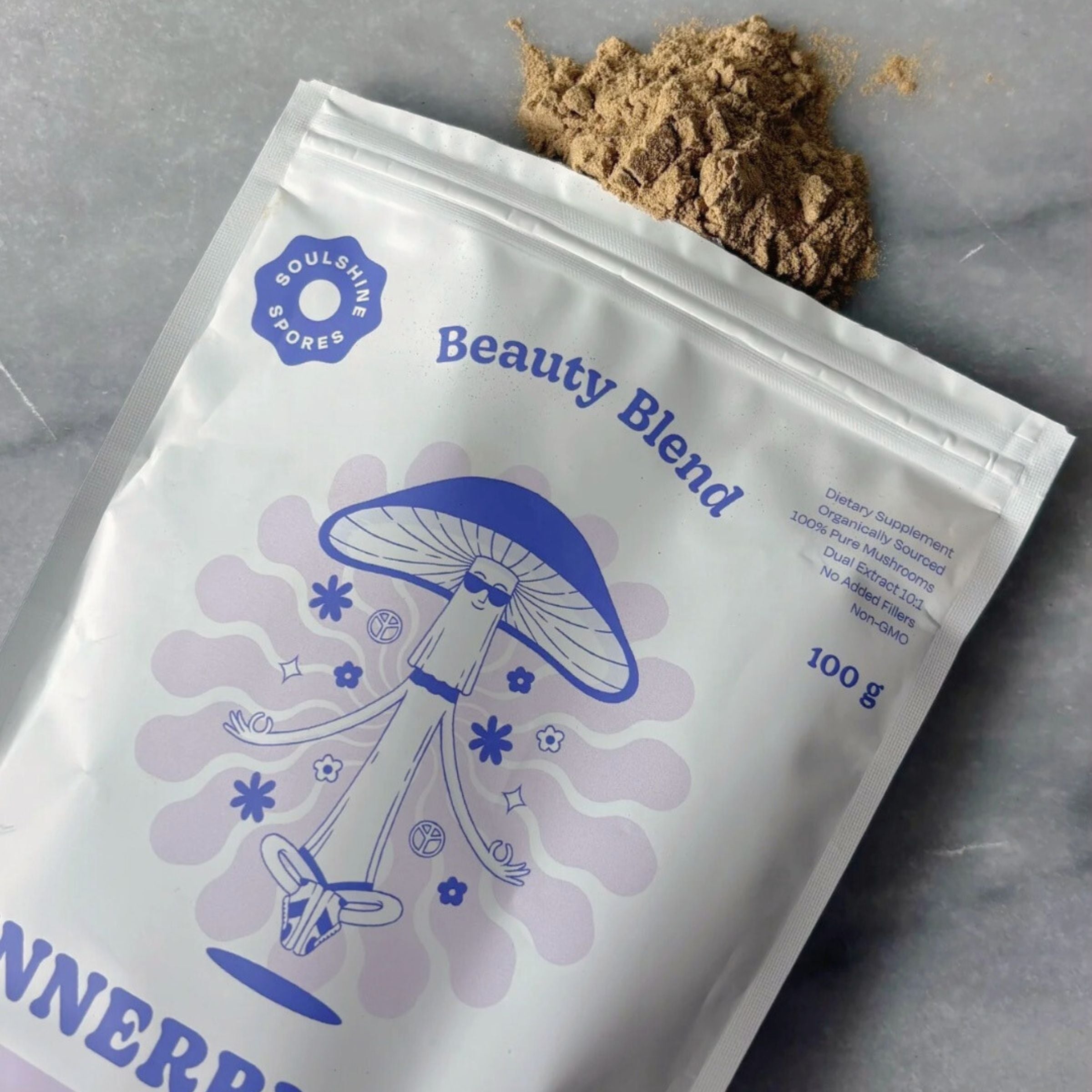 TSoulshine Spores Beauty Blend spilled powder. Certified organic dual-extracted Tremella, Shiitake and Chaga mushroom supplement for skin, beauty and gut heath.