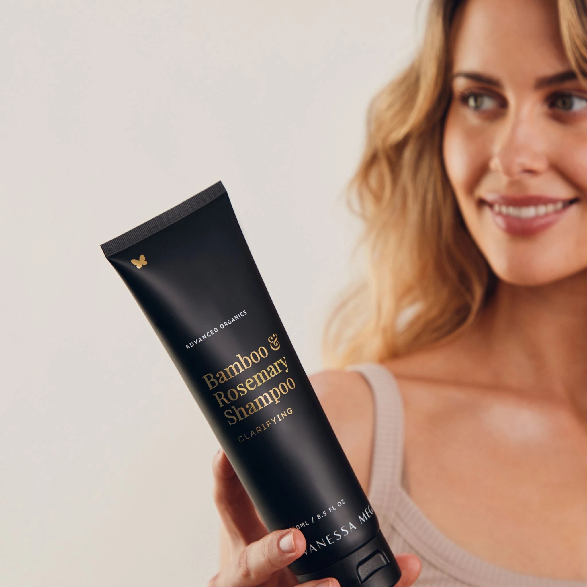Model holding Vanessa Megan Bamboo and Rosemary Clarifying Shampoo – natural clarifying hair care for oily, congested scalps