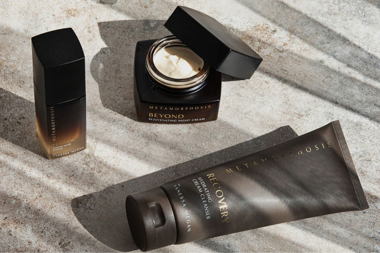 Metamorphosis Skincare by Vanessa Megan peri to post menopausal skincare products featuring Recovery Hydrating Cream Cleanser, Peptide Amino Acid Serum and Beyond Rejuvenating Night Cream styled on stone surface.