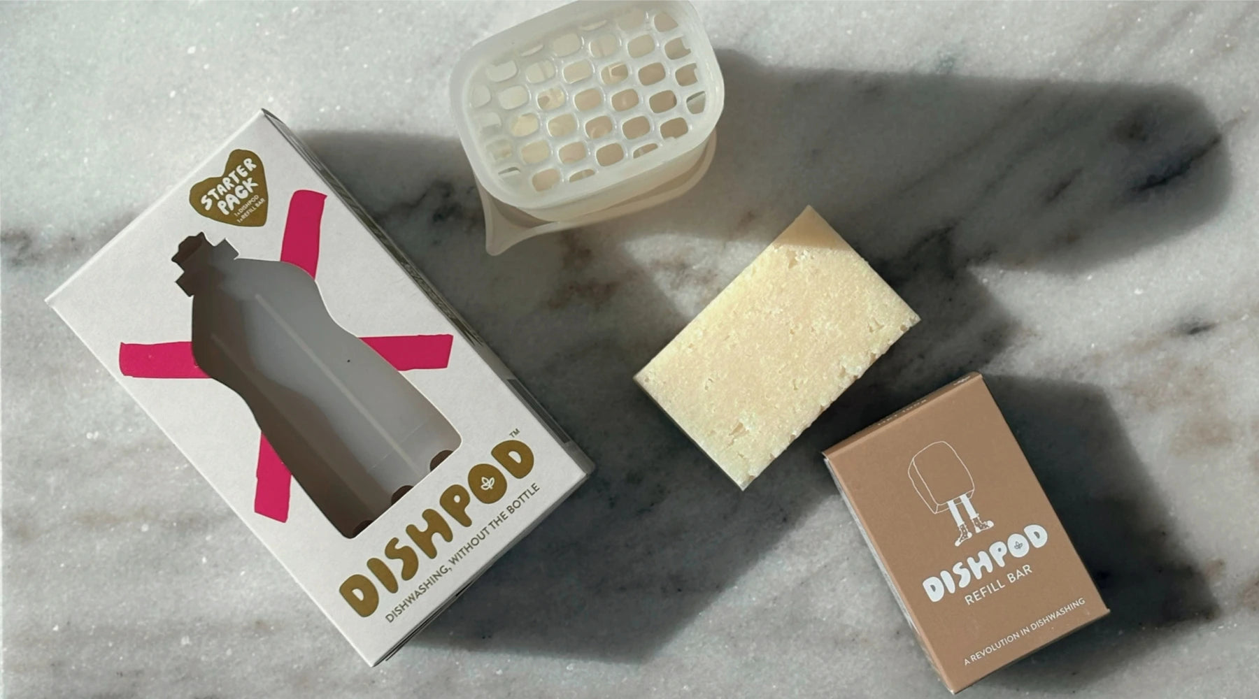 Dishpod starter kit unboxed with solid Dishpod detergent bar refill