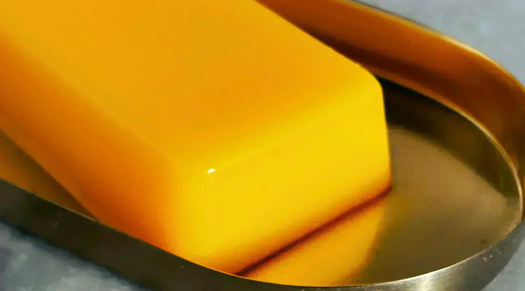 Glorious Golden Ghee bars on a gold tray and marble board in the Intentionally Natural kitchen – nutrient-rich and perfect for cooking, featured in Intentionally Natural NZ's recipe blog.