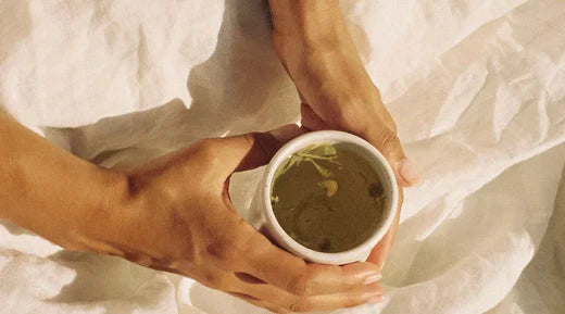 Hands Holding a calming cup of On Sundays herbal tea