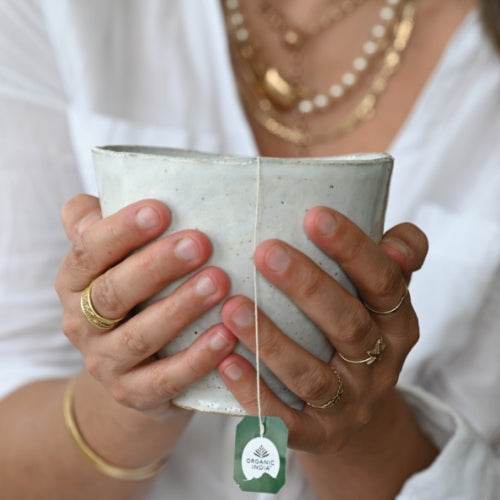 Organic India Tulsi tea hands holding cup 