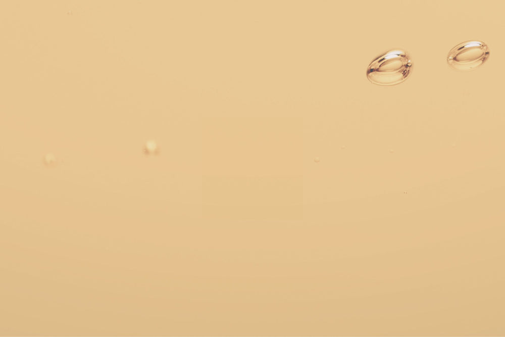 Golden-hued liquid representing amino acids from Rice Bran Extract and L-Arginine known for supporting collagen production, strengthening the skin barrier and enhancing renewal for hormonally affected skin.