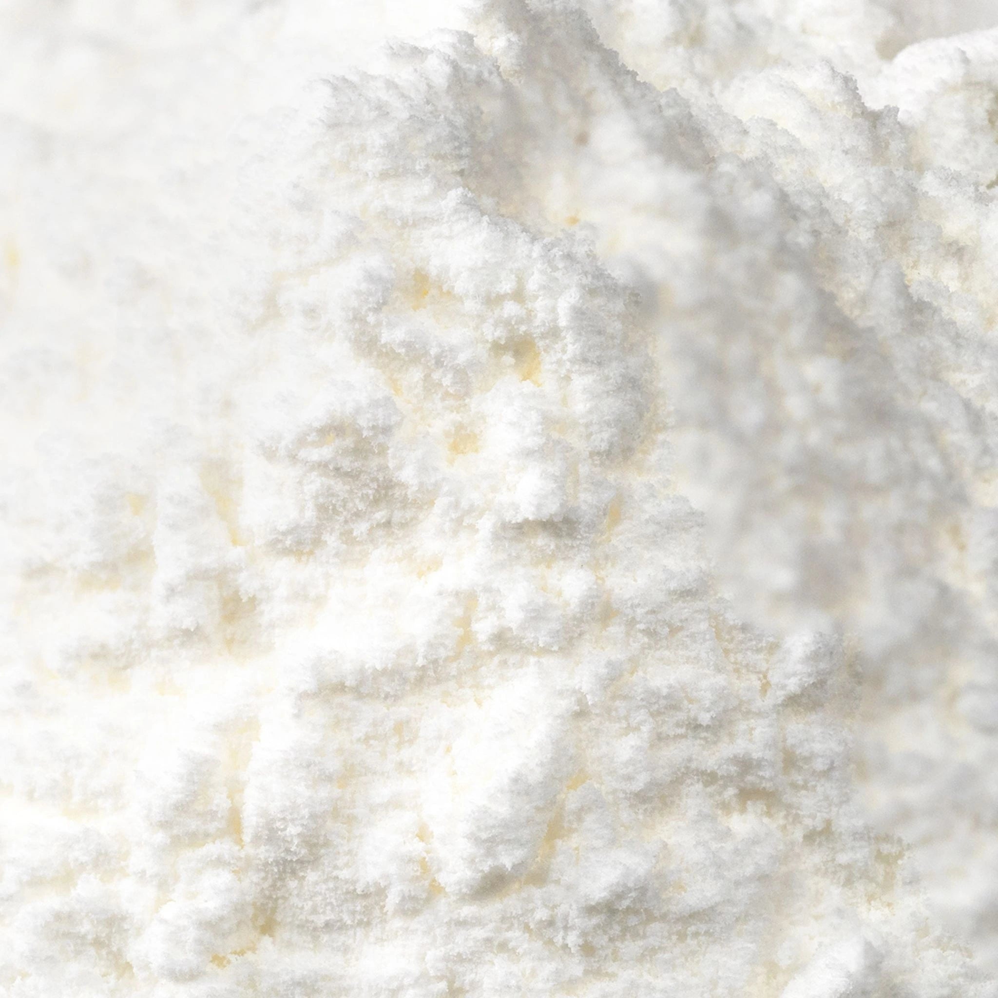 Macro view of pure white allantoin powder, a soothing and skin-conditioning active ingredient known for promoting cell regeneration and supporting sensitive skin in clean skincare formulas.