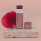 Biode Lilly Pilly natural lip balm open to show rich tint, placed on travertine with rose petal