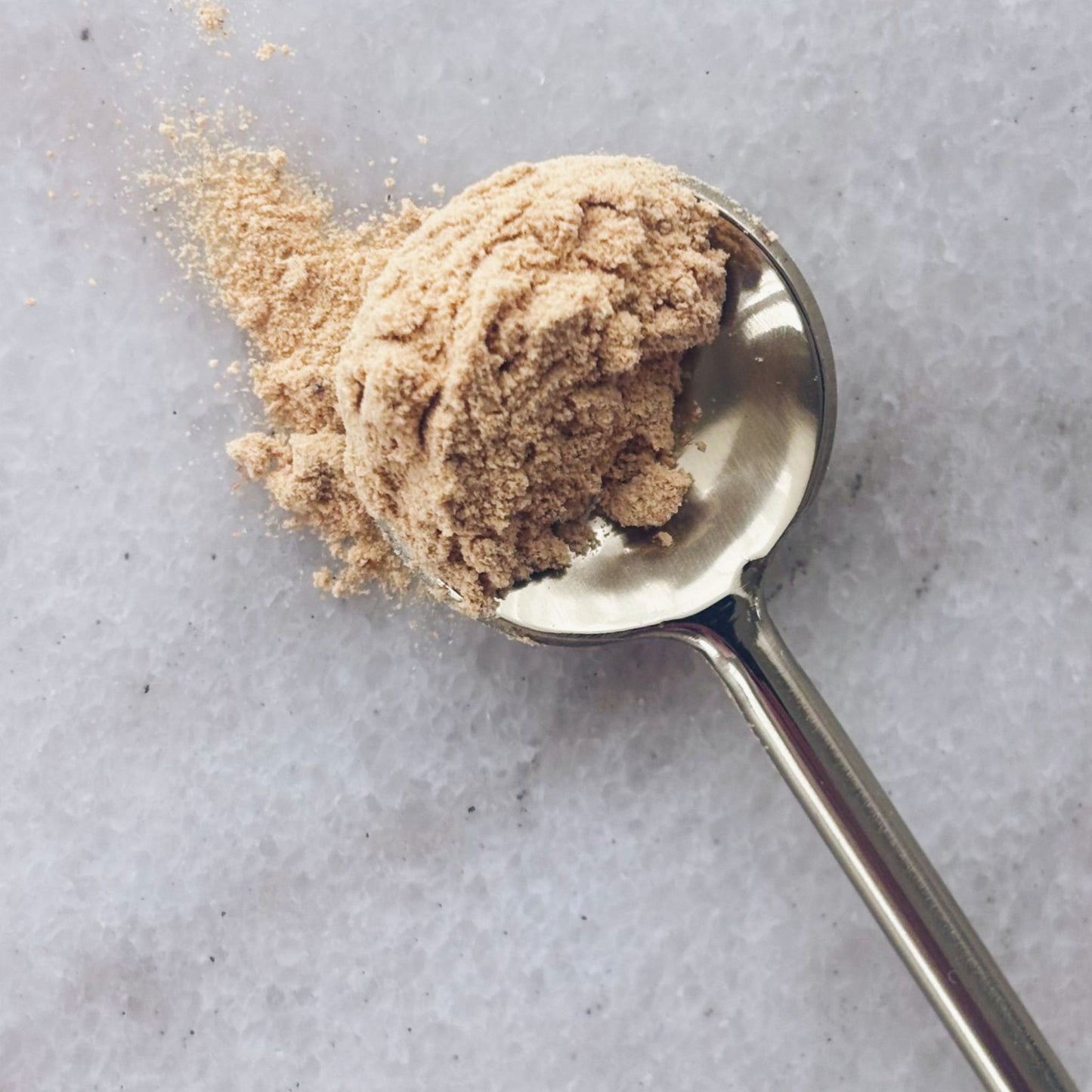 one serving of the Matakana Superfoods Black Maca Root Gelatinised Powder on gold spoon