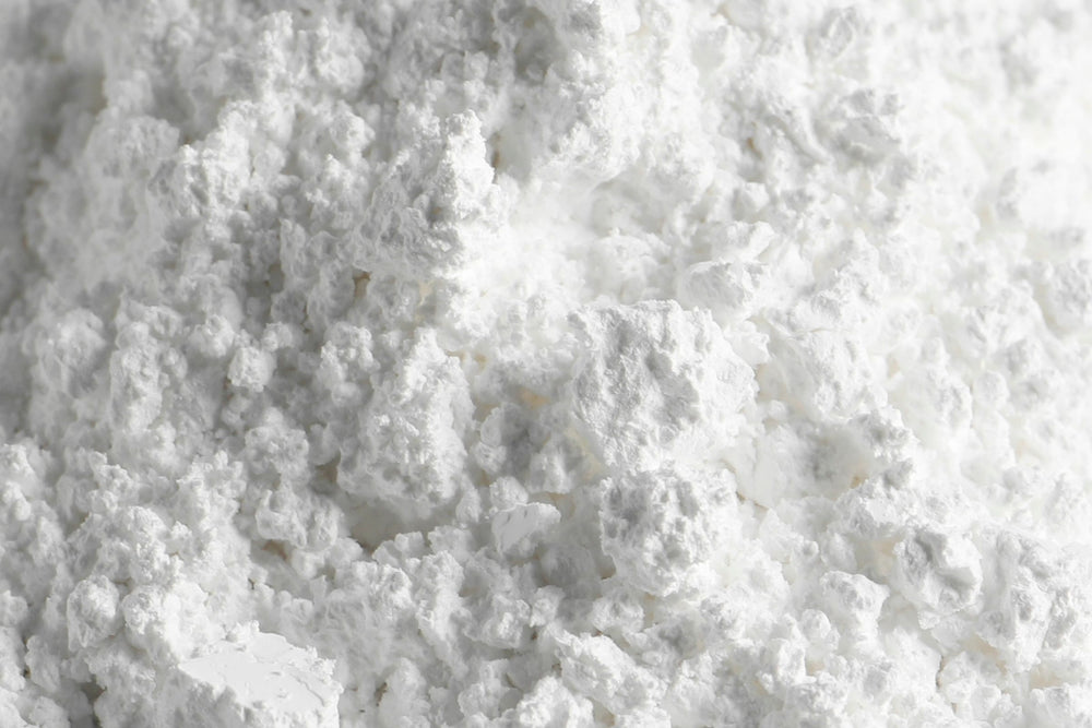 Close up texture of calcium carbonate mineral powder used in oral care skincare and wellness formulations.