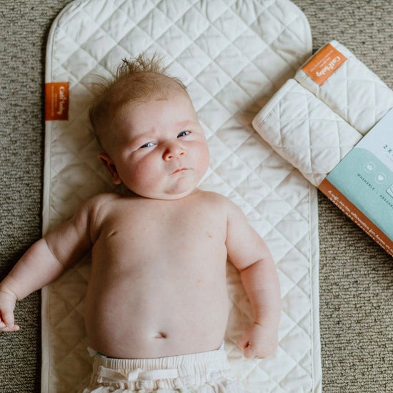 Baby lying on CaliWoods Reusable Changing Mat – organic cotton, washable and low waste alternative to disposable change mats NZ