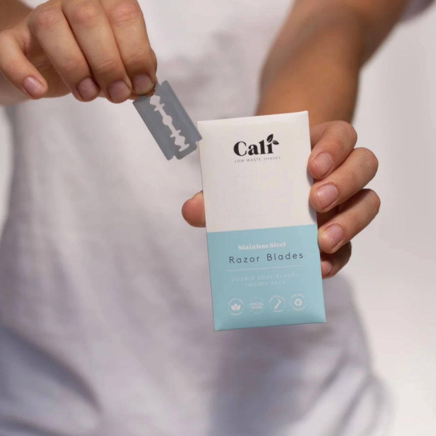 Holding CaliWoods Stainless Steel Razor Blades 20 pack – zero-waste double edge blades for sustainable shaving NZ