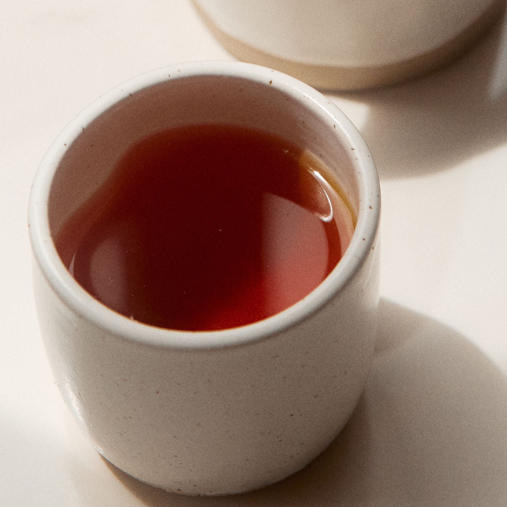 On Sundays Earl Grey black tea with bergamot brewed to a warm amber hue in ceramic cup