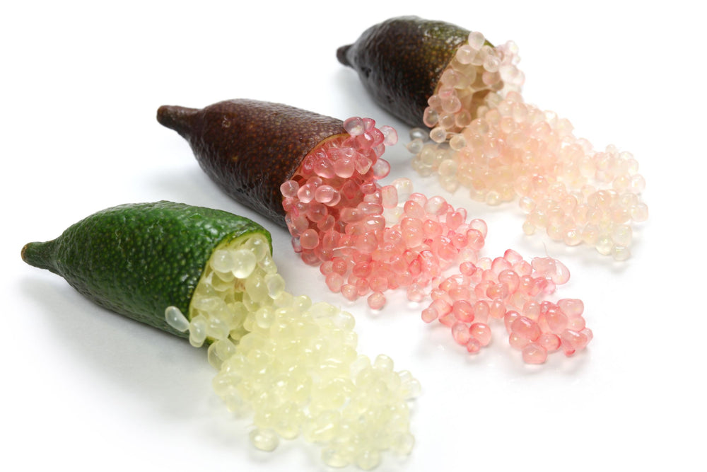 Fresh finger limes split open revealing citrus pearls in green, pink and pale tones, key ingredient image representing finger lime rich in natural AHAs, vitamin C and antioxidants, used in beauty, skincare, supplements, teas and wellness products for gentle exfoliation, digestive support and overall vitality.
