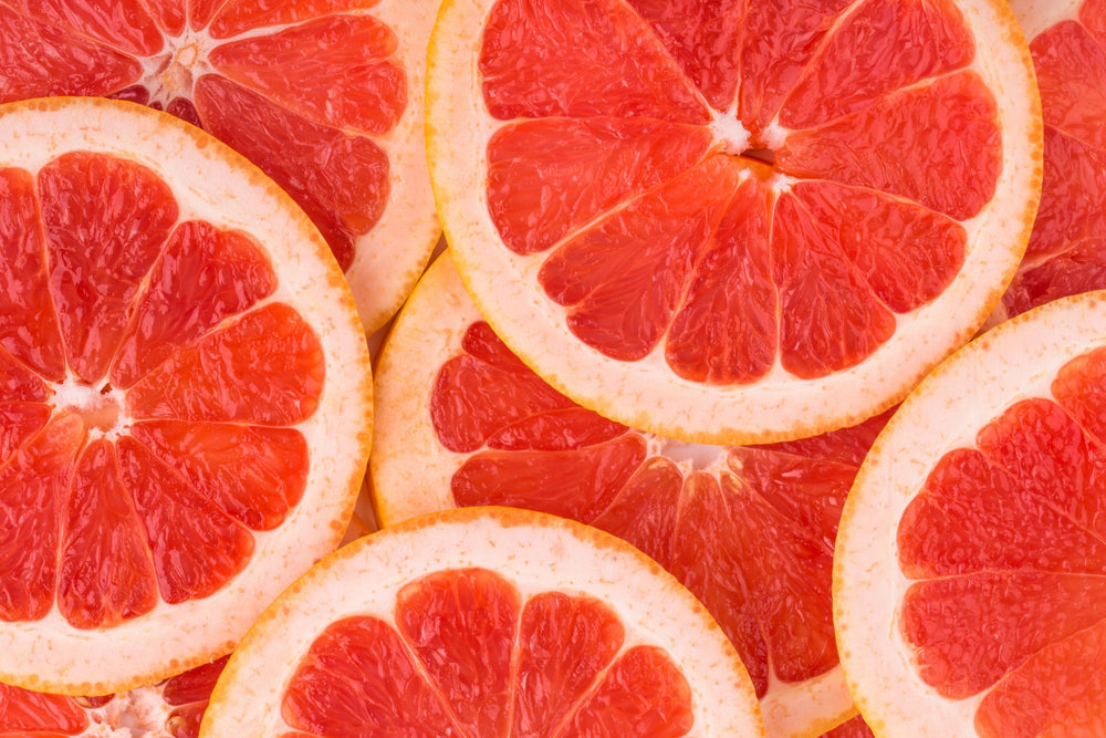Fresh pink grapefruit slices antioxidant rich citrus botanical used in skincare beauty and wellness.