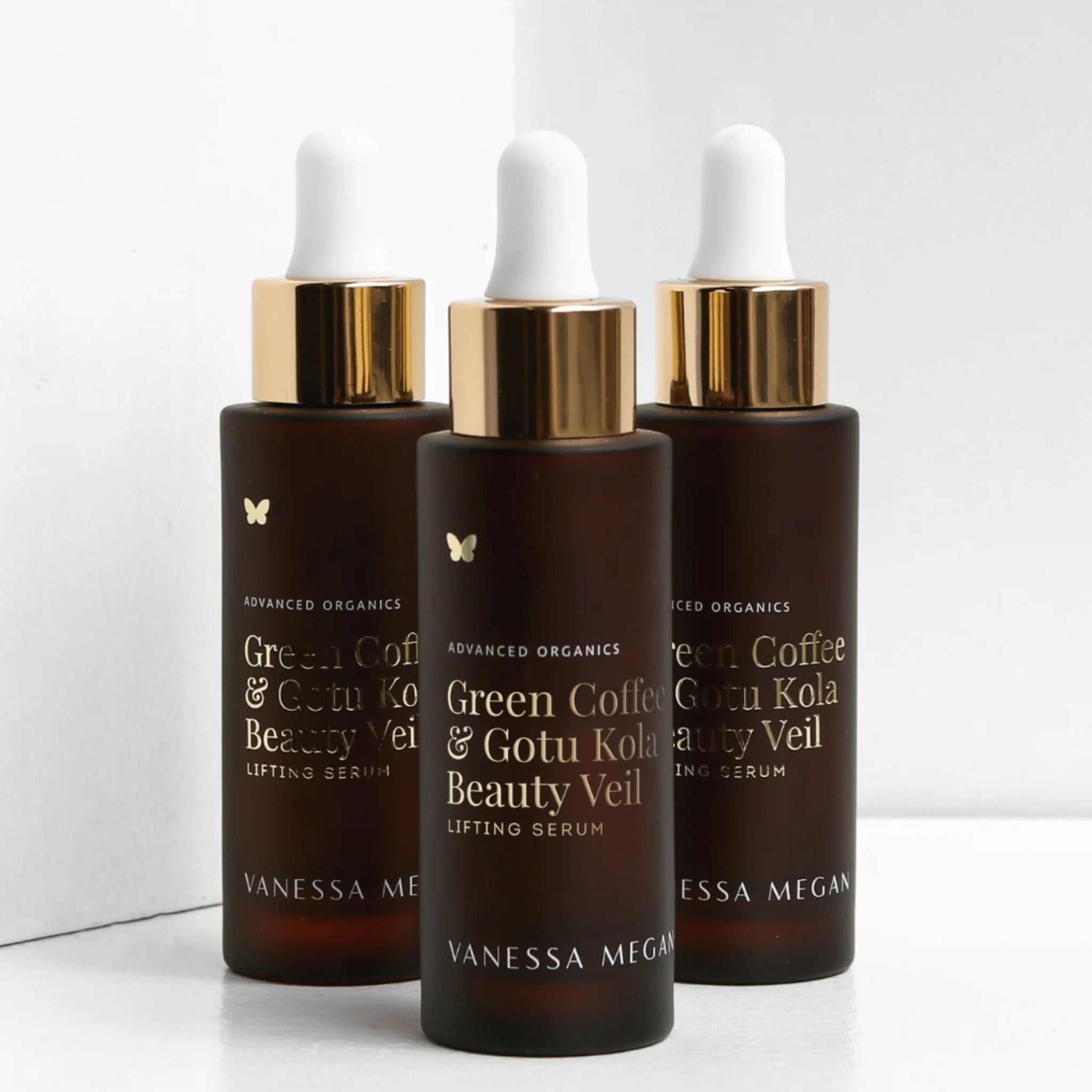 Three bottles of Vanessa Megan Green Coffee and Gotu Kola Beauty Veil lifting serum for natural firming and skin vitality.