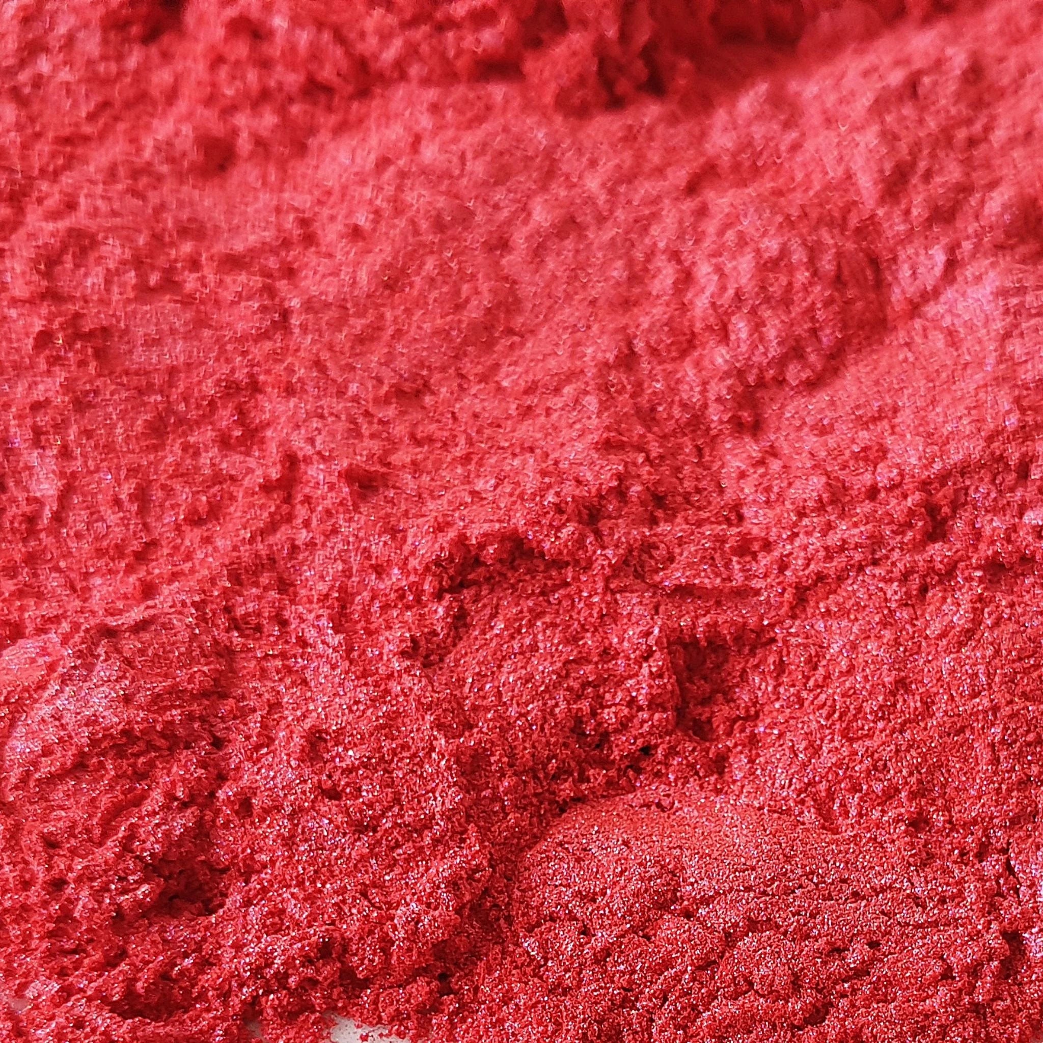 Vibrant red iron oxide pigment powder, a natural mineral colorant used in authentically natural beauty formulations for safe, non-toxic makeup and skincare.