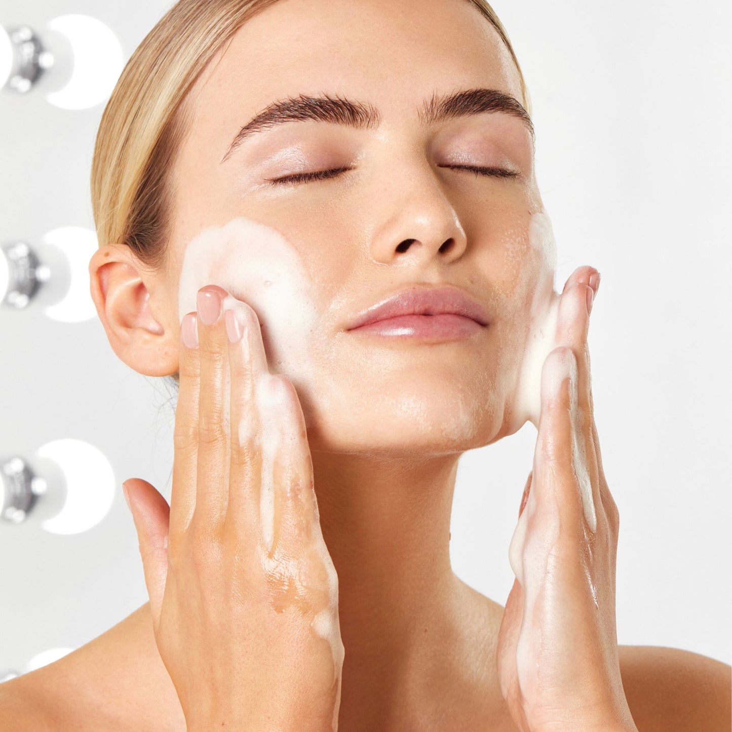 Woman cleansing her face with Vanessa Megan Papaya Enzymatic Foaming Cleanser, demonstrating the rich foaming texture and gentle daily cleansing ritual.