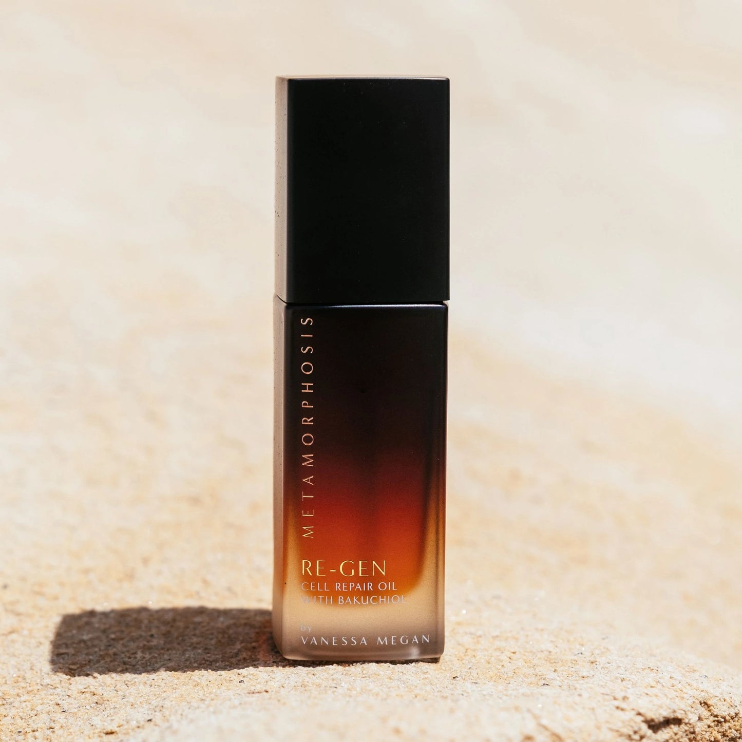 Vanessa Megan Re-Gen Cell Repair Oil pump bottle with Bakuchiol photographed on natural sand