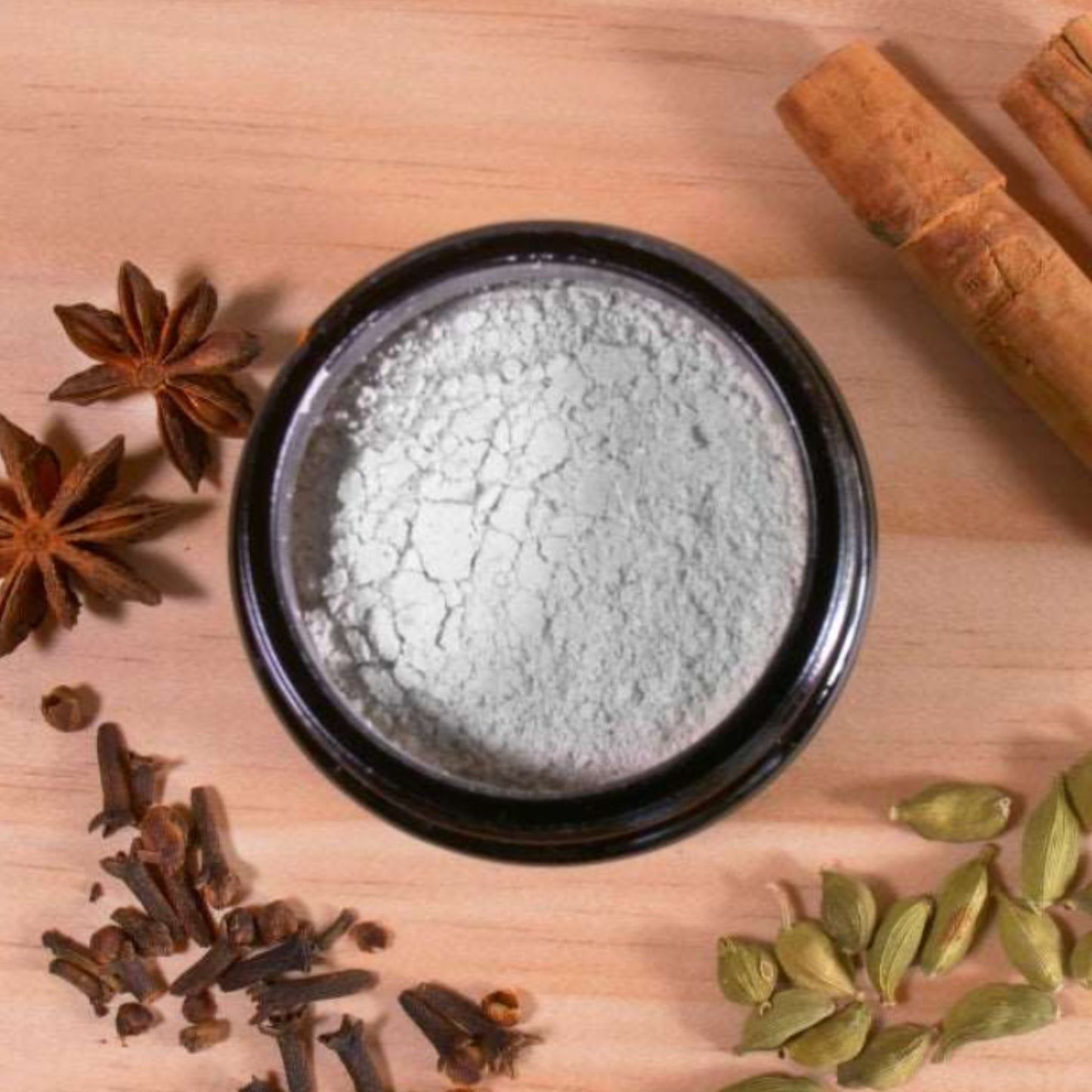 Overhead view of Maxwell and McIntyre Mineralising Toothpowder with NZ kelp natural whitening powder surrounded by star anise cloves cardamom and cinnamon.