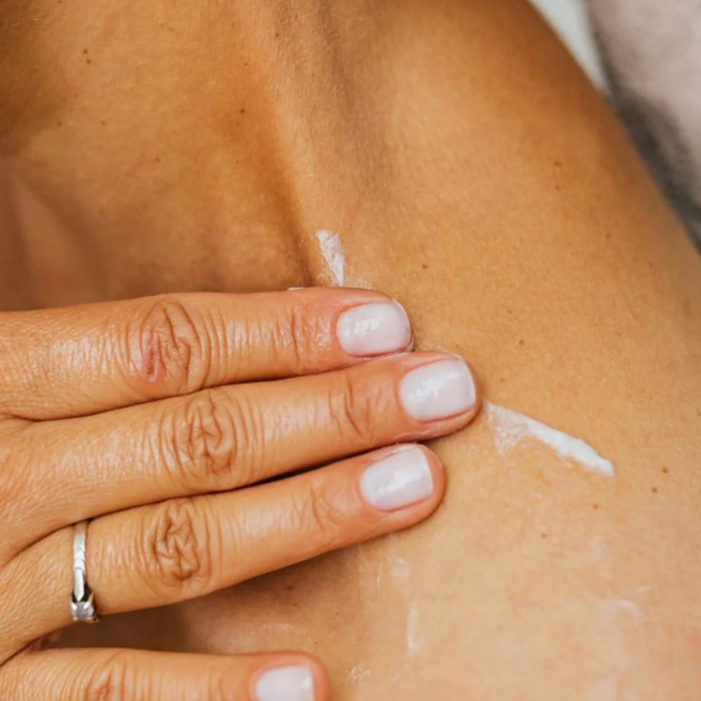Close-up of women applying the Metamorphosis Skincare Wild Yam Concentrate Dermal Cream to her neck.