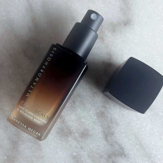 Open bottle of Metamorphosis Cool & Calm Mist with cap off, showing spray nozzle and luxury packaging design, ideal for cooling and calming 