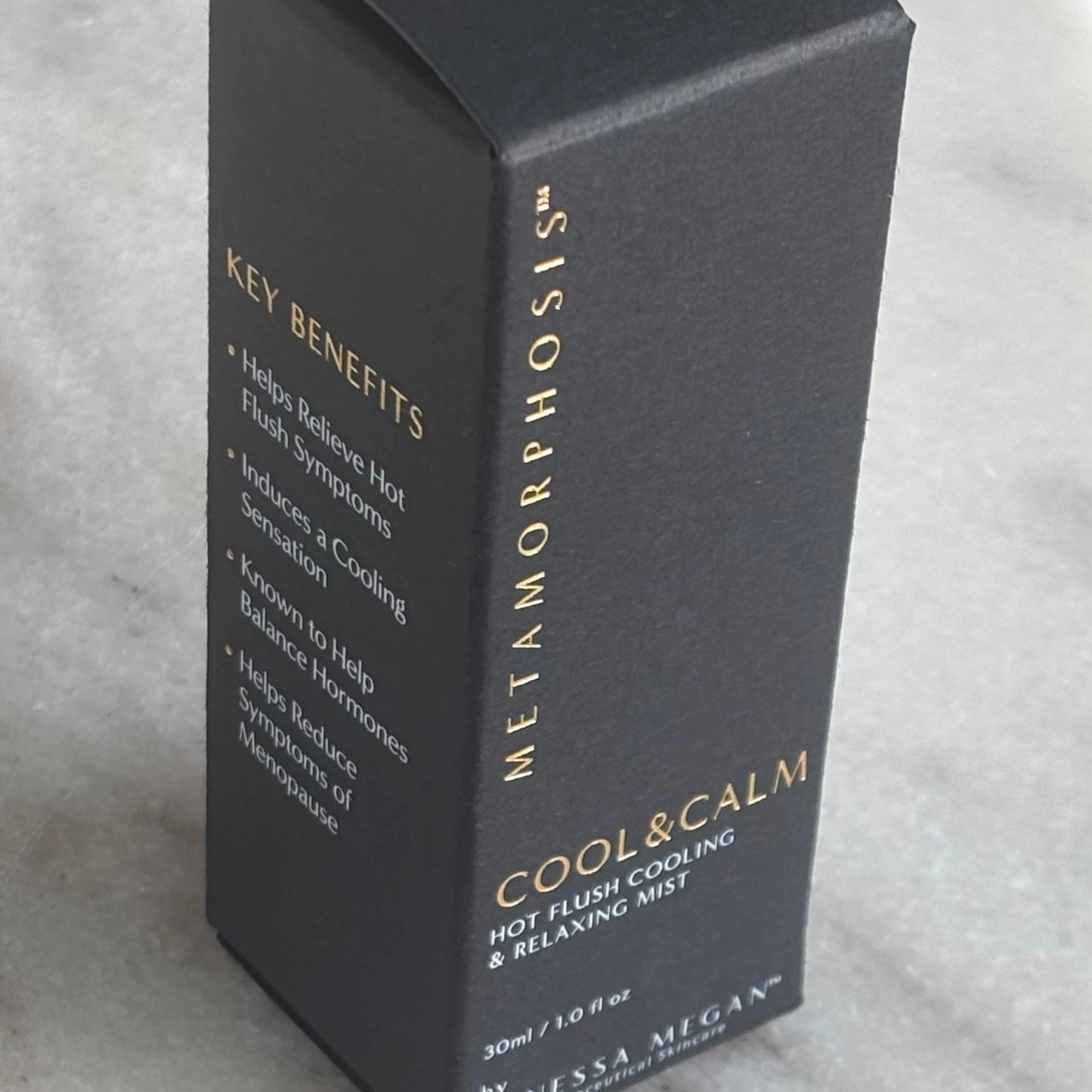 Side view of Cool & Calm Mist product box with gold foil 'Key Benefits' text outlining menopausal hot flush relief and hormone-balancing support.