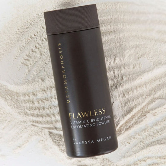 Metamorphosis Flawless Vitamin C Brightening Exfoliating Powder by Vanessa Megan, lying on a bed of fine powder, emphasizing its 100% natural exfoliating formula designed to brighten and smooth menopausal skin.