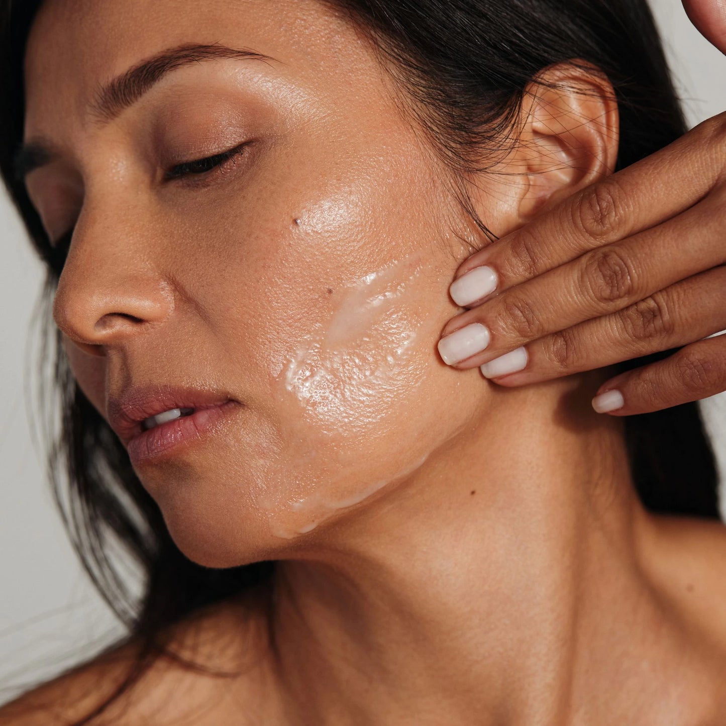 Close-up of peptide serum being applied to the skin.