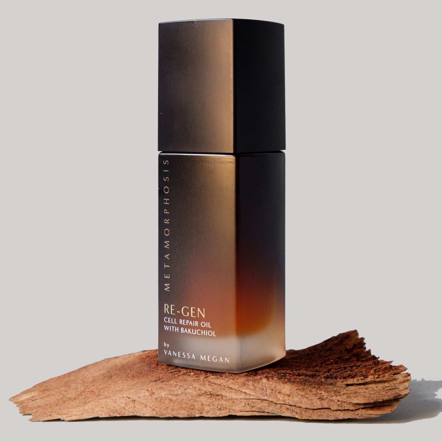 Metamorphosis Re‑Gen Cell Repair Oil with Bakuchiol Skincare for Per to Post Menopausal Skin stands upright on a piece of natural bark.