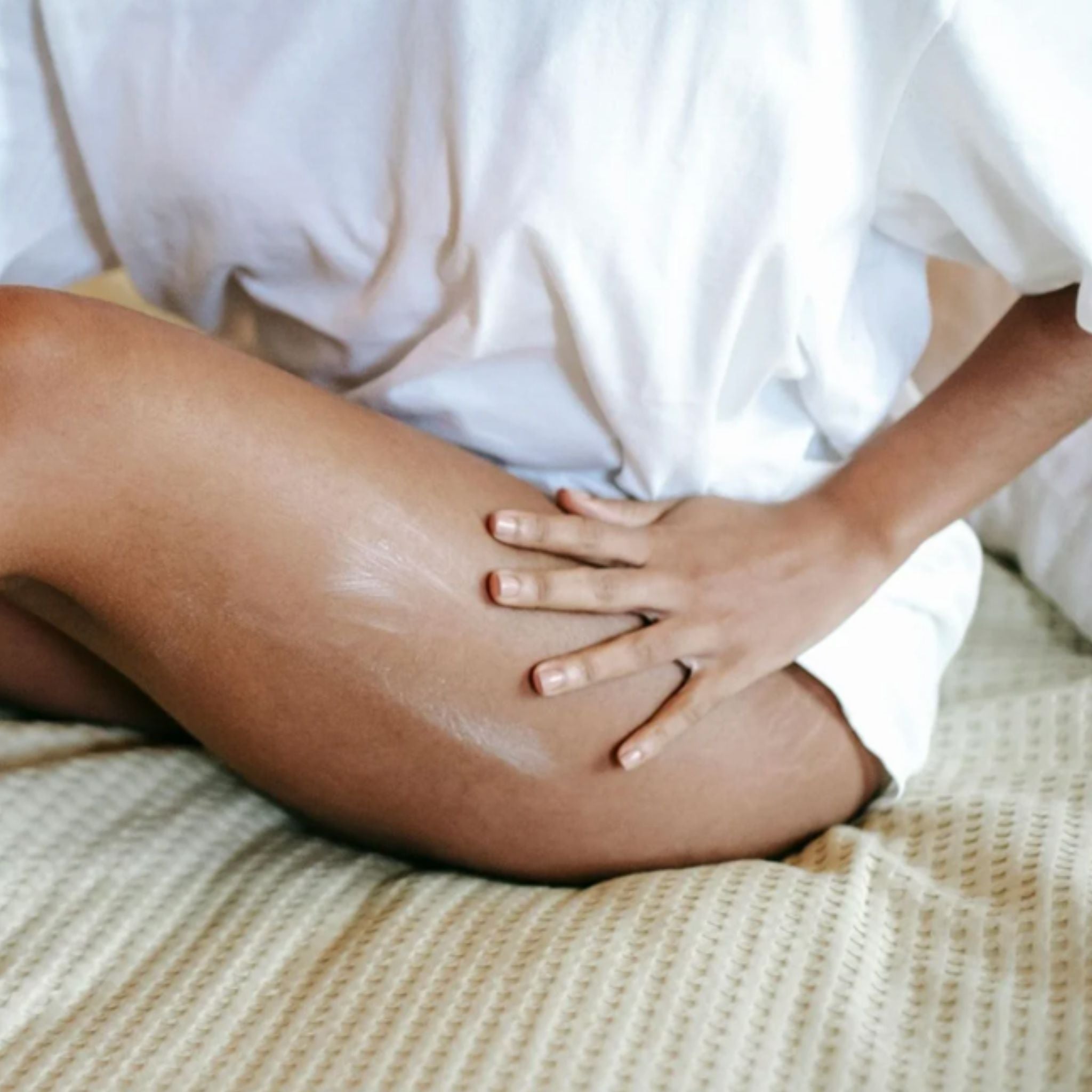 Women applying the Metamorphosis Skincare Wild Yam Concentrate Dermal Cream to the thigh area.