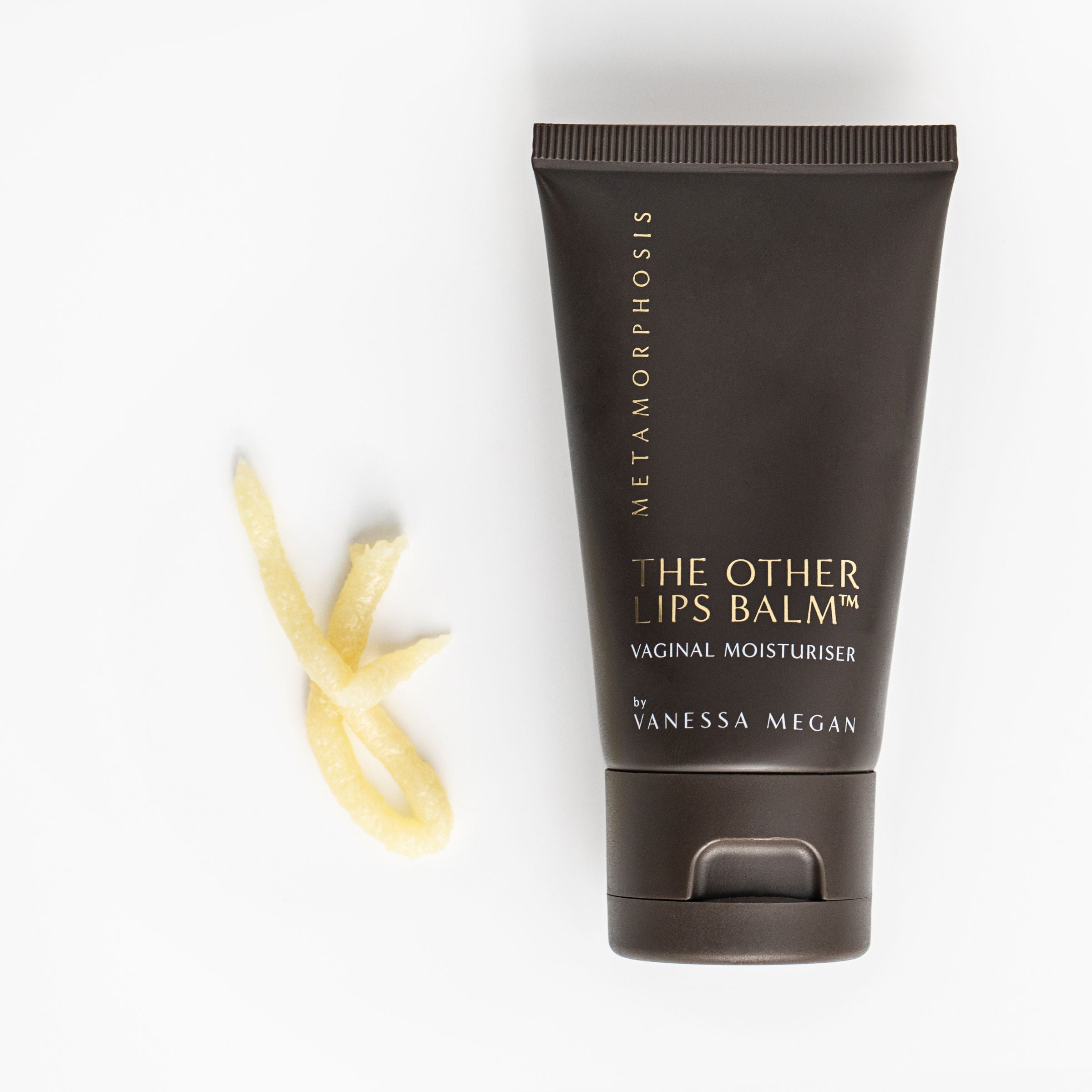 Metamorphosis The Other Lips Balm Vaginal Moisturiser by Vanessa Megan, shown with a soft swirl of balm texture beside the tube, highlighting its rich, soothing formula designed for intimate skin hydration.