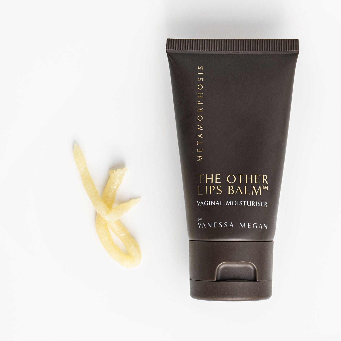 Metamorphosis The Other Lips Balm Vaginal Moisturiser by Vanessa Megan, shown with a soft swirl of balm texture beside the tube, highlighting its rich, soothing formula designed for intimate skin hydration.