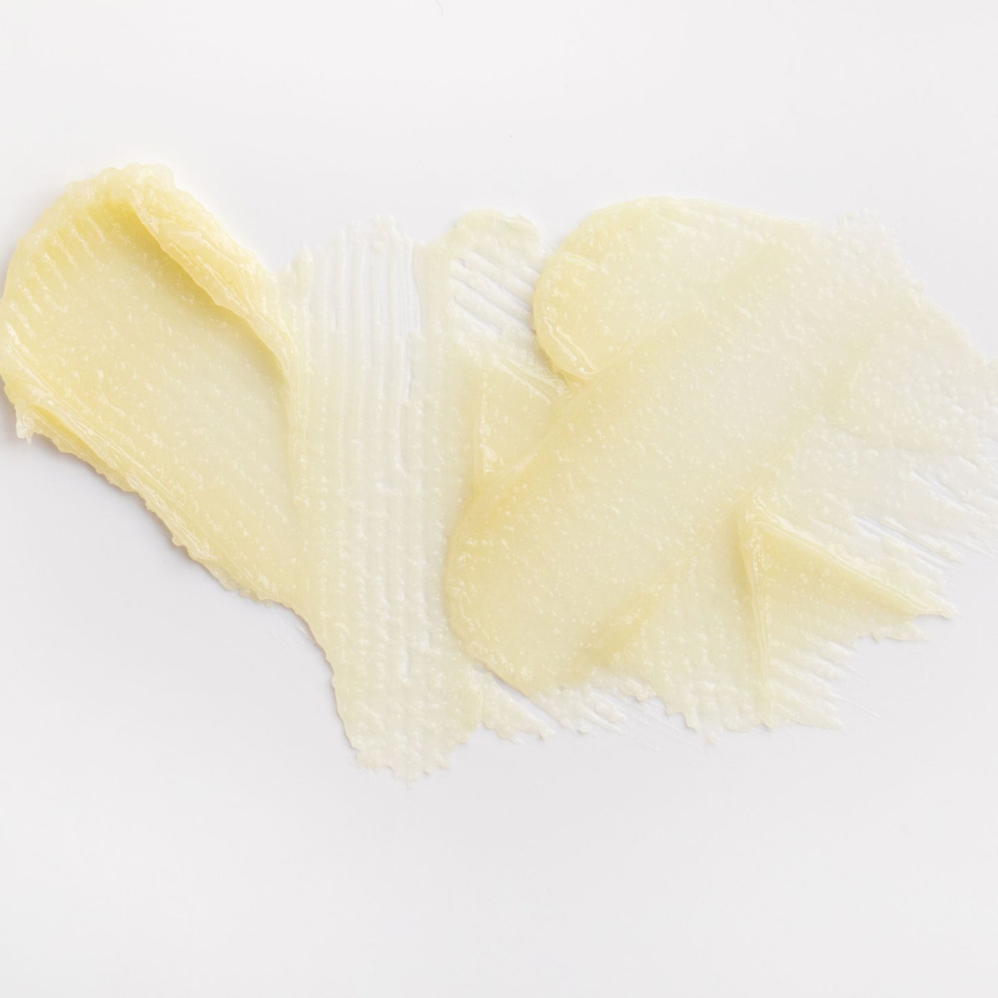 Close-up of Metamorphosis The Other Lips Balm vaginal moisturiser swatched on a white surface, showing its smooth, nourishing balm texture.