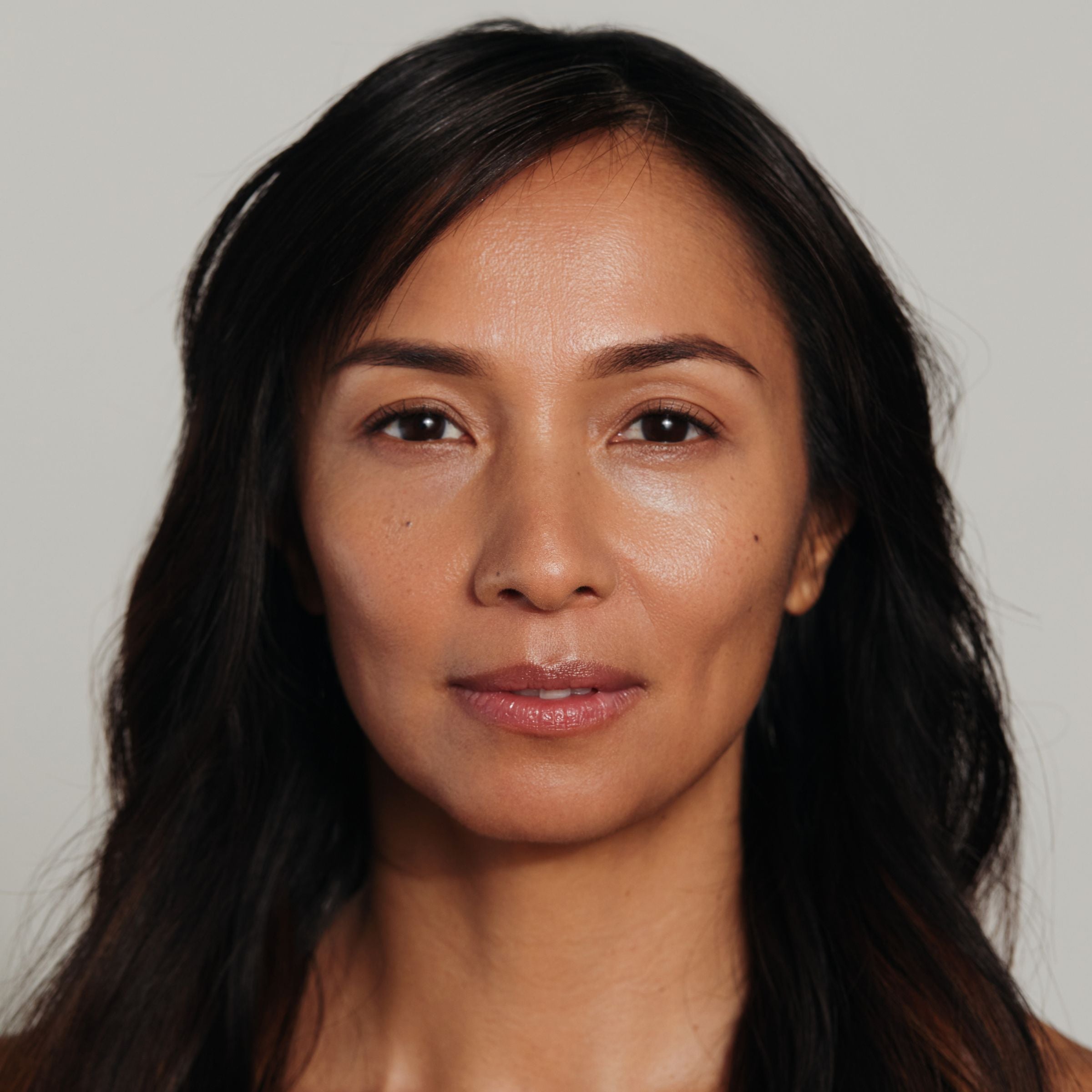 Model with radiant, smooth skin prepped using Metamorphosis Flawless Vitamin C Brightening Exfoliating Powder and Vanessa Megan skincare, highlighting a healthy, luminous complexion.
