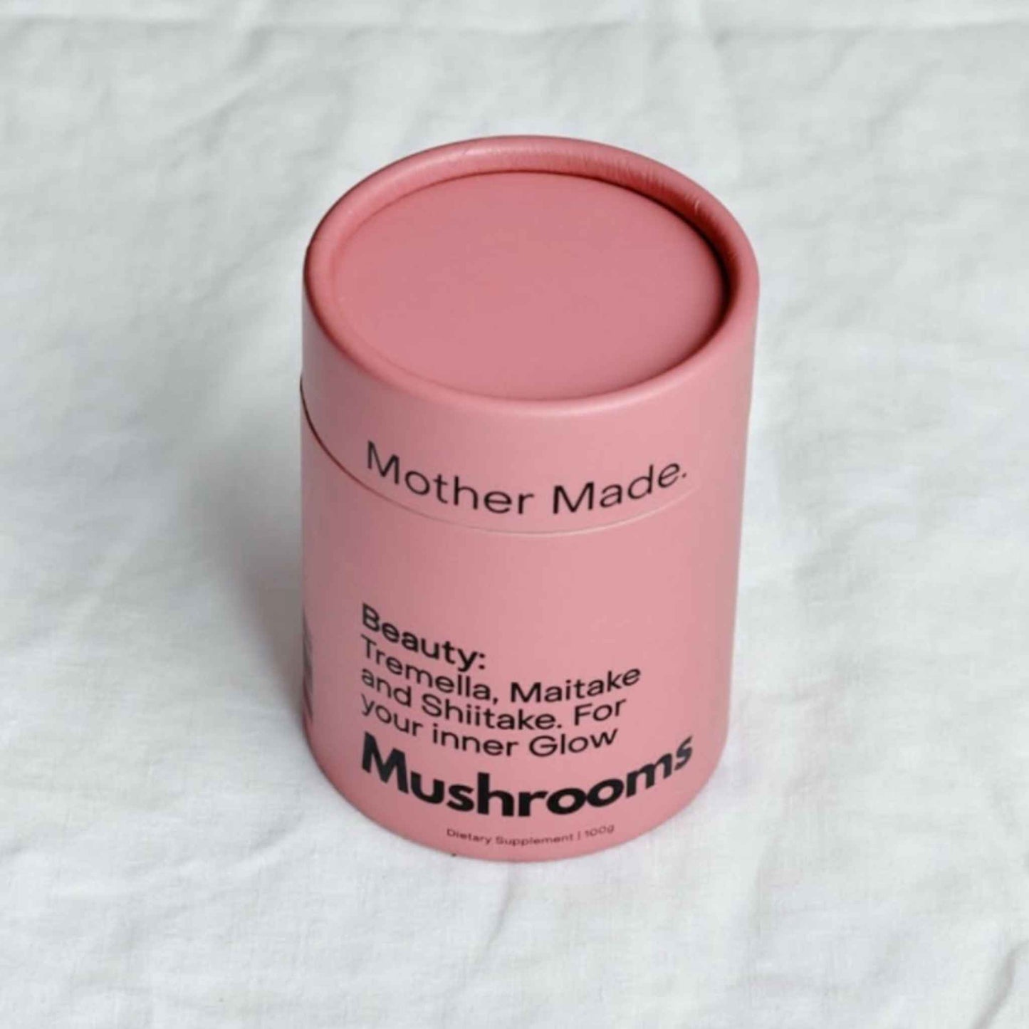 A pink cylindrical tin of 'Mother Made. Beauty: Tremella, Maitake and Shiitake.