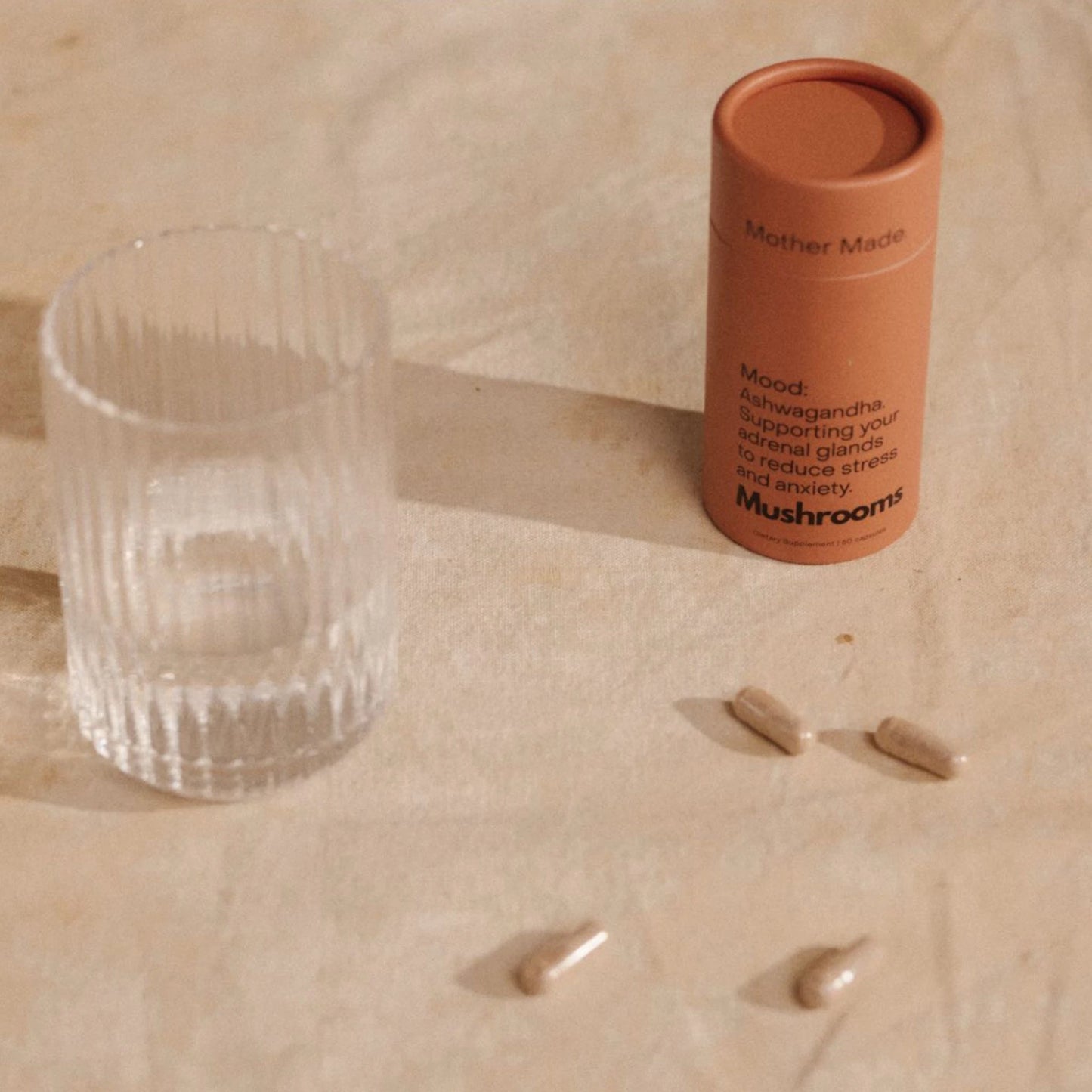 Mother Made Mood Ashwagandha Capsules next to glass, ideal for calming daily use