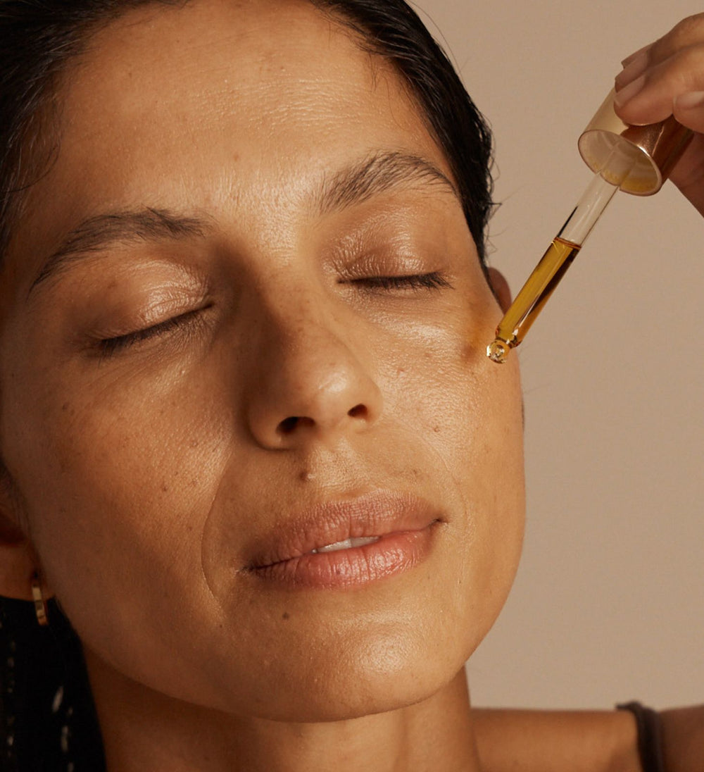 Women applying Vanessa Megan N.E.O face oil 100% natural organic skincare serum to face at Intentionally Natural New Zealand
