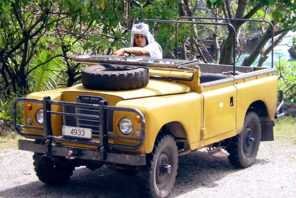 Andy Cory the know locally as the 'Honeyman', the Pacific’s leading apiculturists and the man behind Niue honey. Pictured here in a yellow vintage off-road vehicle on the island of Niue.