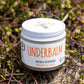 No3 Underbalm Patchouli and Citrus natural deodorant jar photographed outdoors on native greenery.