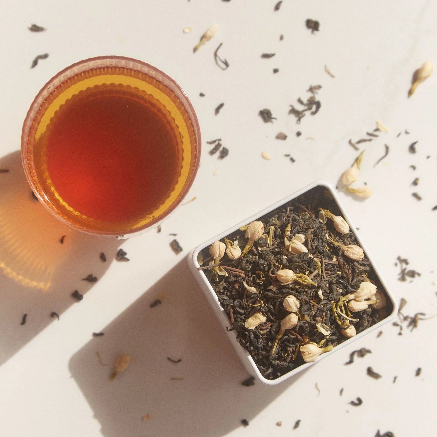 brewed On Sundays Green Jasmine Tea beside its loose leaf tin