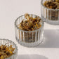 On Sundays Unwind Lose Leaf Organic Tea blend of organic chamomile, calendula, and lavender in glass jars.