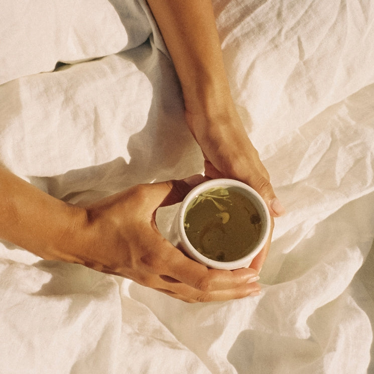 Hands holding On Sundays tea in cup