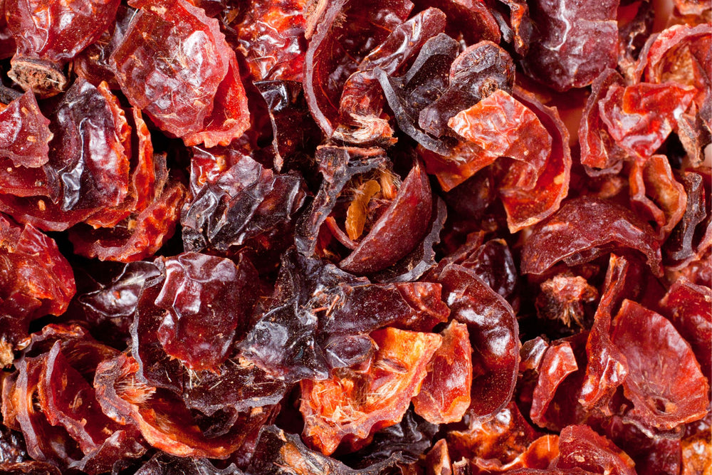 Close up of dried rose hips rich in natural vitamin C used in herbal tea blends wellness products and botanical beauty formulations.