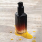 Vanessa Megan Re-Gen Cell Repair Oil with Bakuchiol  golden oil drips of the face oil.