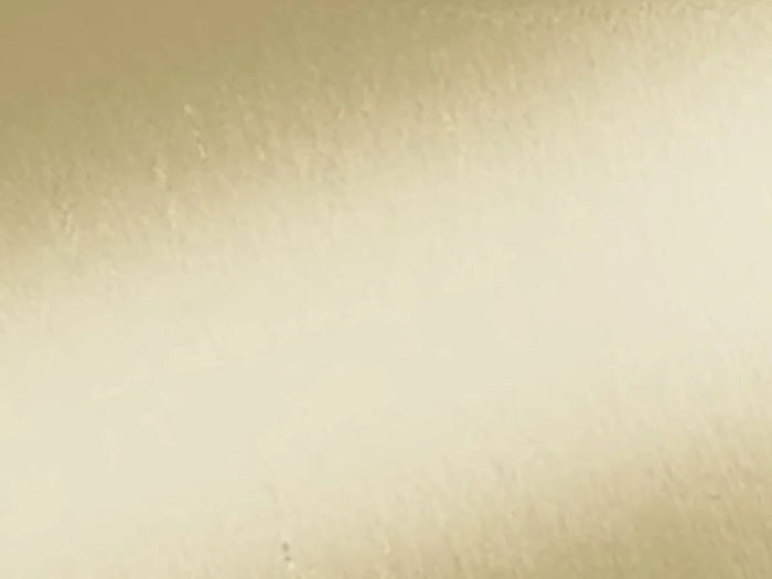 Close-up of vēr वेर Kansa Gua Sha showing smooth, golden Kansa metal surface for natural facial massage and skin rejuvenation